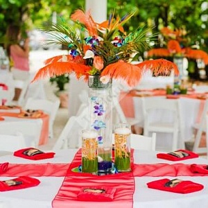 Украшение свадебных столов в оранжевом цвете с перьями