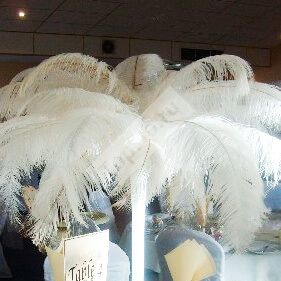 Цветочная композиция на стол гостей с перьями в белом цвете