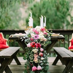 Украшение стола гостей листьями и розовыми цветами